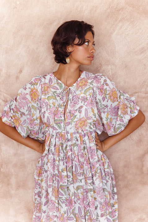 Daughters of India Kyra Midi Dress in Fuchsia Bloom — close-up neckline tie and billowed sleeves by terracotta wall