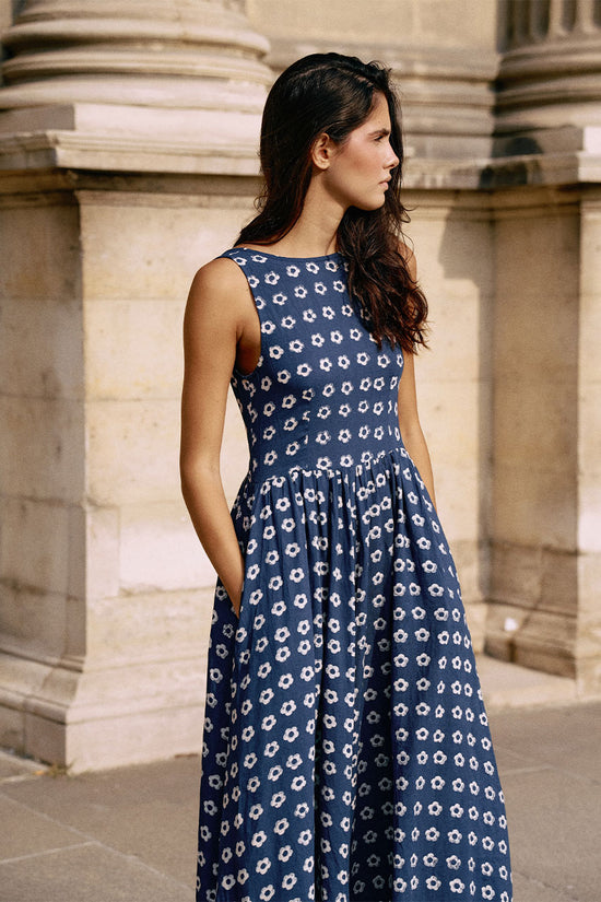 Veda Dress Indigo — outdoor movement shot, model wearing indigo hand block print linen blend midi dress with flowing fabric, natural light setting, artisan Jaipur India | Daughters of India
